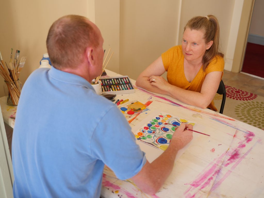 An Individual art therapy session involves talking and making art.